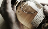Jacquie Kubin lifts a toast of 1991 to John Ramsay, malt master for The Glenrothes Single Malt Scotch Whiskey since the mid-1990s who has retired.