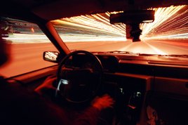 In Cartesian geometry, the vanishing point is often represented by a pine tree air freshener. Driver's eye view of the road.