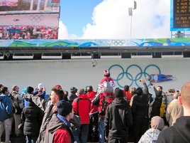 Spectators raise their cameras to snap a shot. Spectators raise their cameras to snap a shot.