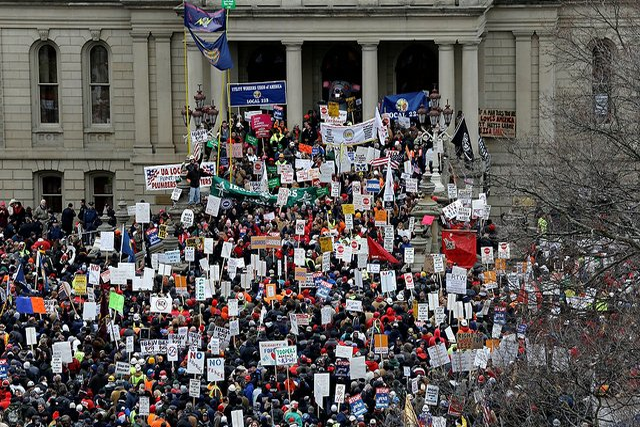 Following the passage of the right to work bill in Michigan, pro-union protesters resorted to thug tactics, including repeatedly assaulting a conservative on-watcher.