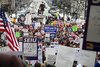 Thousands gather in Michigan to protest controversial right-to-work legislation. 