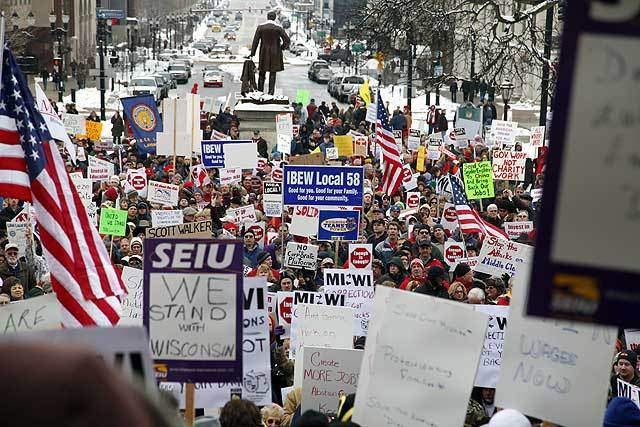 Thousands gather in Michigan to protest controversial right-to-work legislation. 