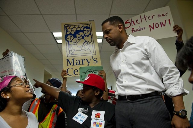 D.C. Council Chairman Kwame Brown addresses Aiyi'nah Ford (left), the emcee for a group of community services organizations and homeless people, outside his office at the Wilson Building in Washington, D.C. on Thursday, May 10, 2012. About 200 people came down to the Wilson building to ask council members to allocate funding in the FY 2013 budget for things like affordable housing and homeless services. Brown said that he would commit to finding ways to get them some money, but he could not commit to a specific dollar amount. (Barbara L. Salisbury/The Washington Times)