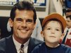 Five-year-old Drew Storen sits on the lap of his father Mark, a sportscaster. Baseball and other sports were a major part of their lives as Drew was growing up and on his way to becoming a relief pitcher for the Nationals.