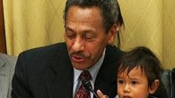Raw: Congressman Balances Questions, Kid on Lap