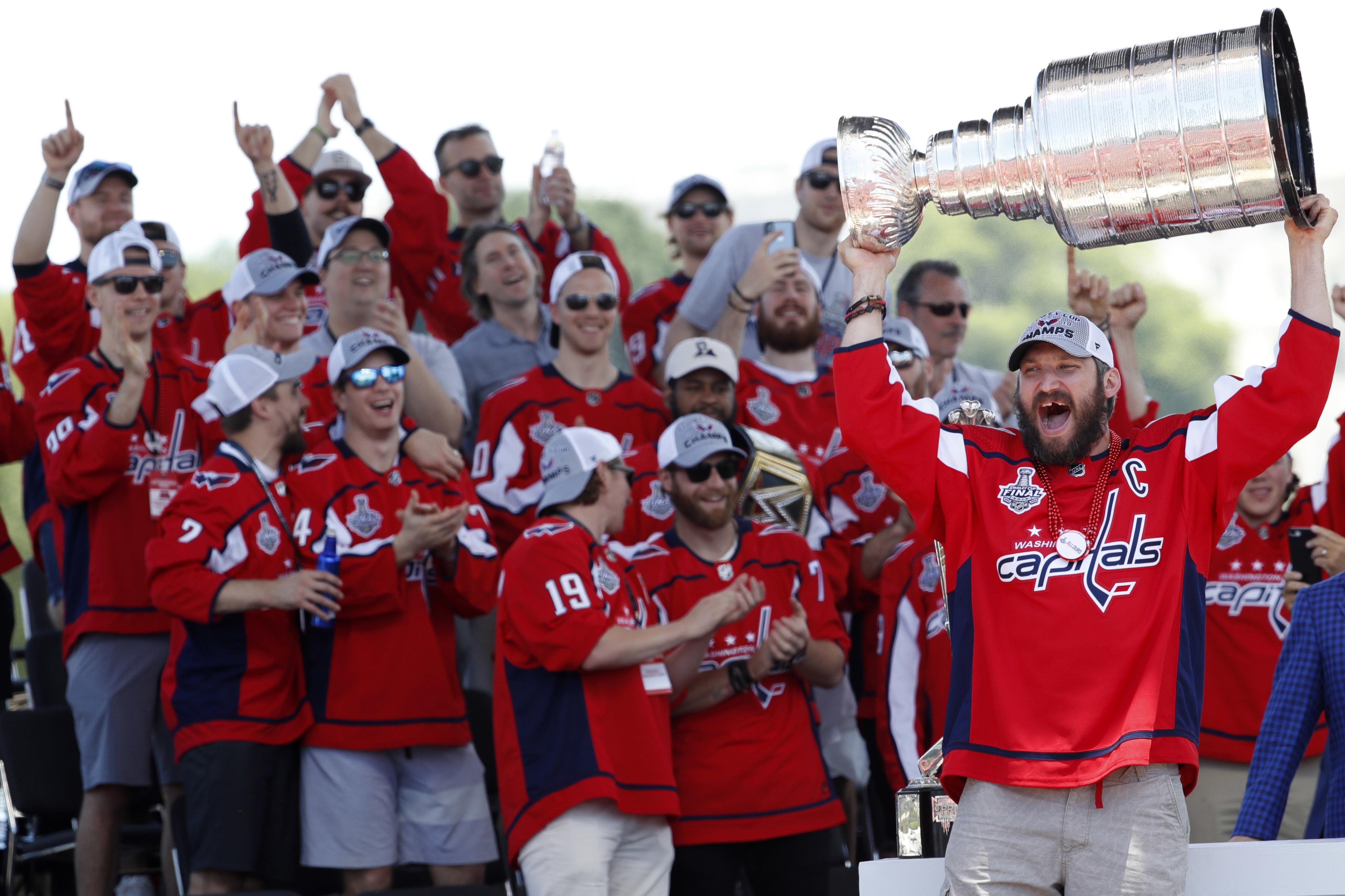 Washington Capitals' T.J. Oshie chugs a beer through his jersey at Stanley  Cup rally 