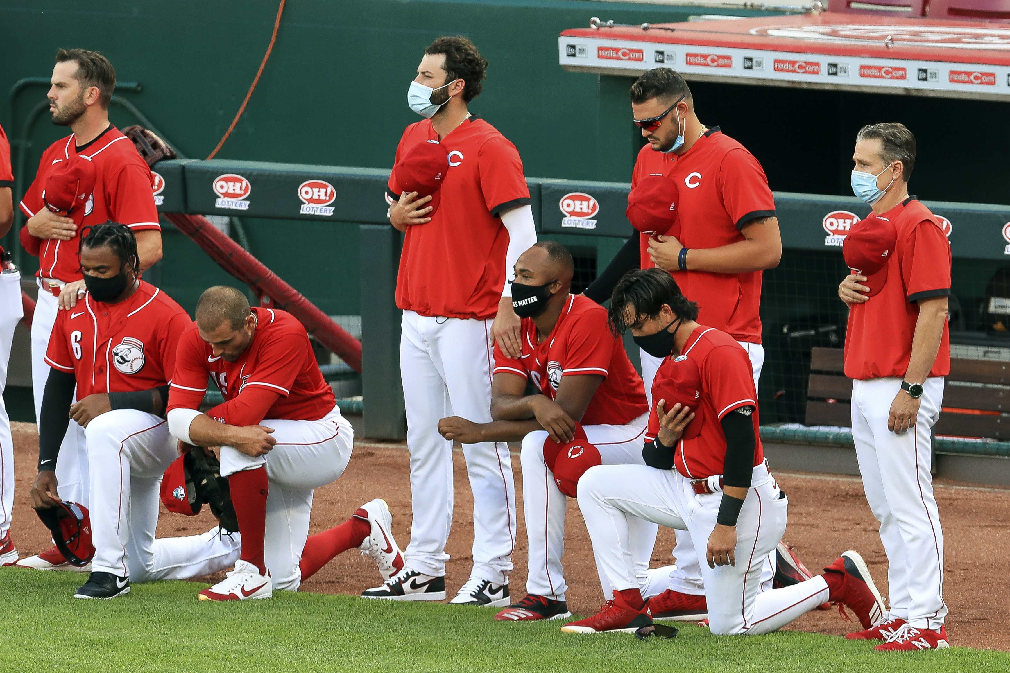 Giants Jewish manager Gabe Kapler kneels during playing of