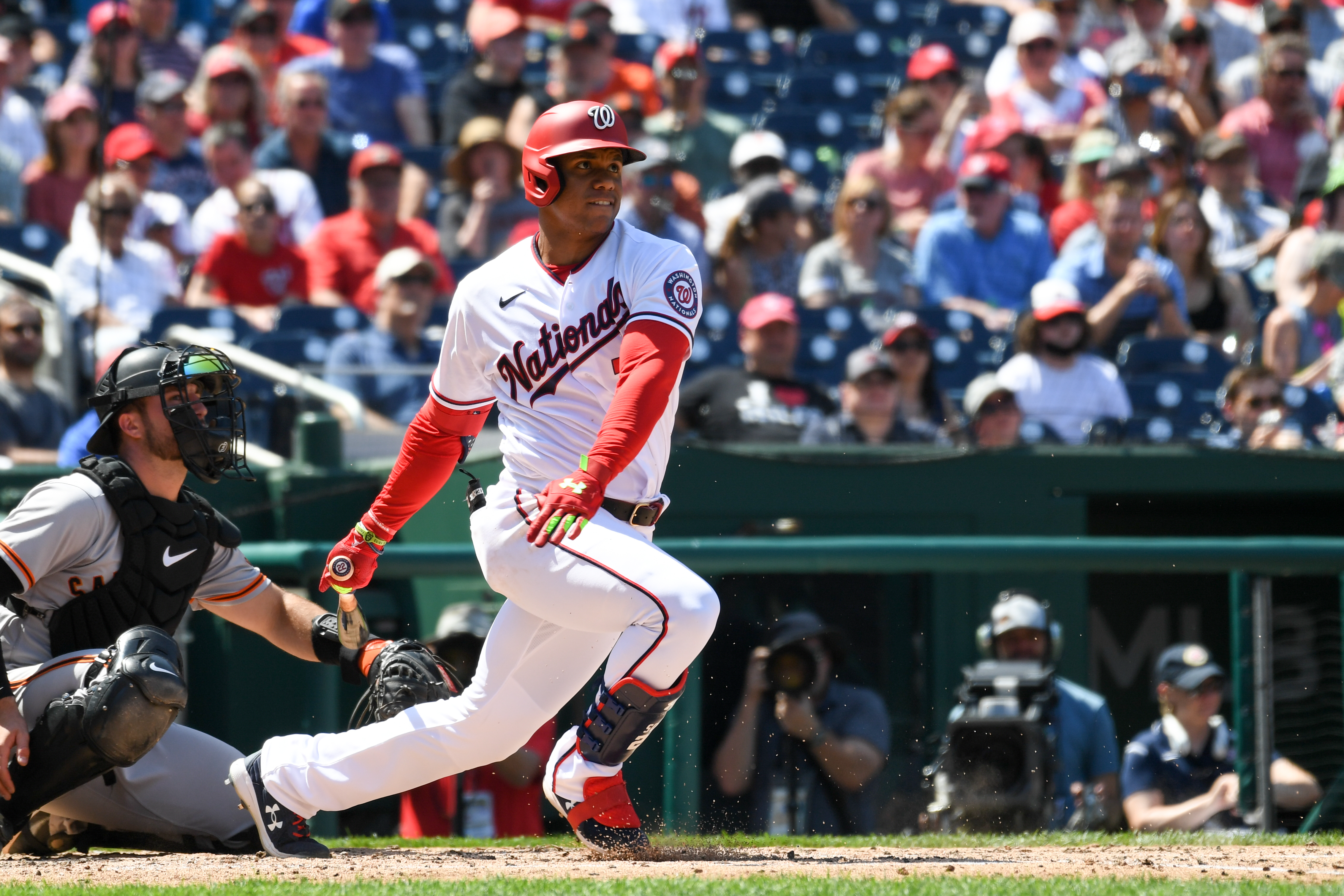 Washington Nationals' Juan Soto, front, stands in the dugout