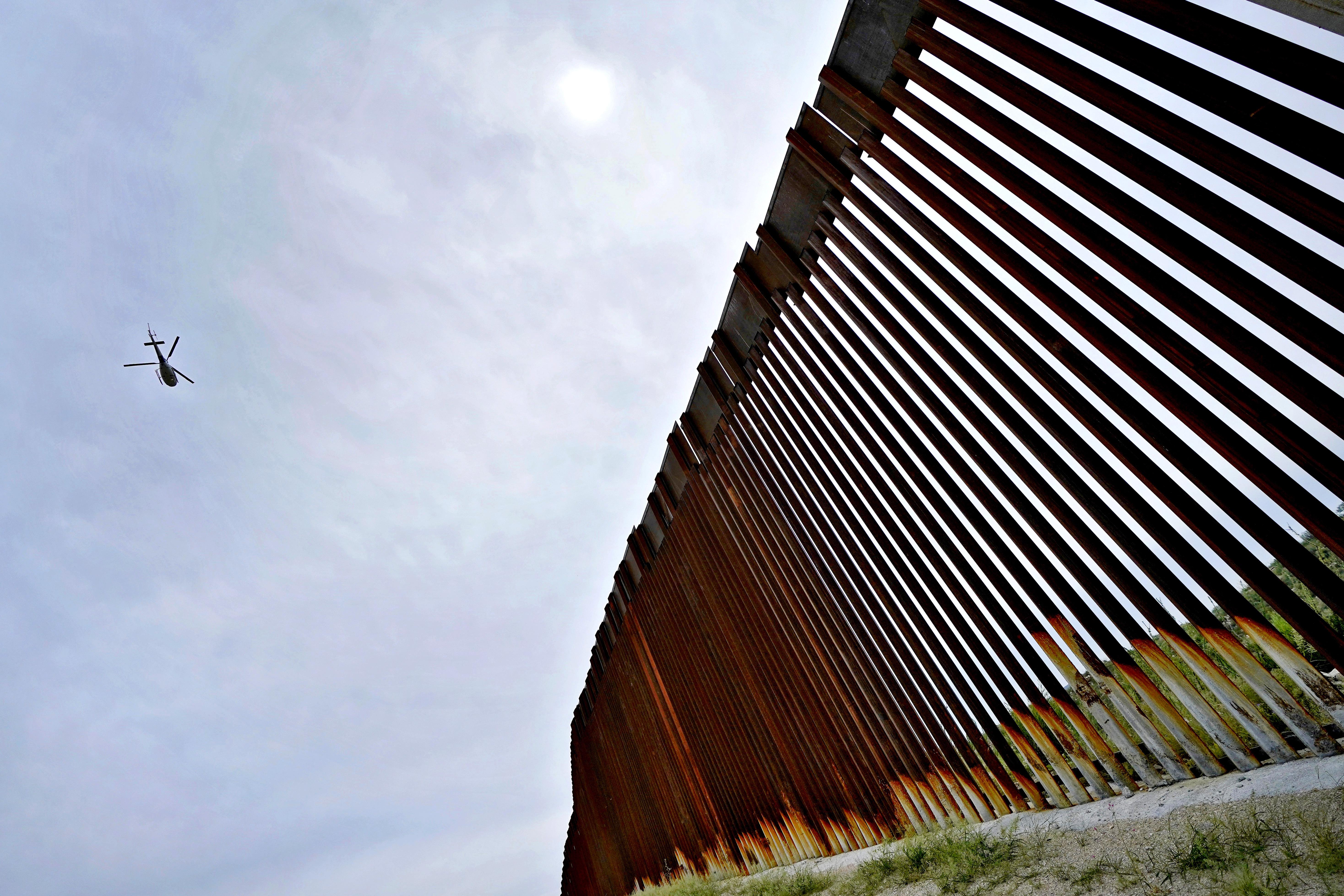 U.S. Customs agent David Gonzalez helps a traveler from Mexico use