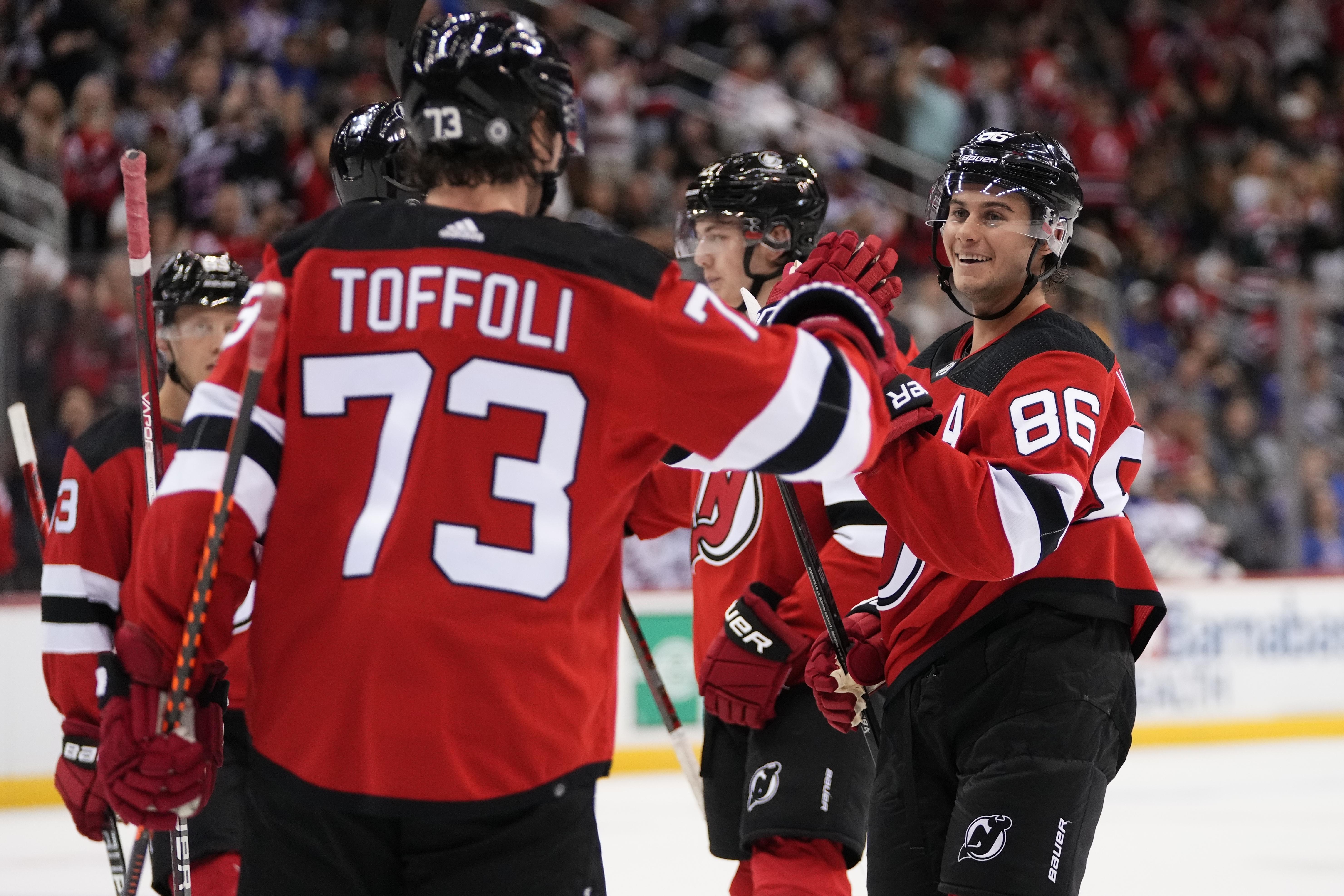 New Jersey Devils defenseman Luke Hughes (43) celebrates after his winning  goal in overtime of an NHL hockey game against the Washington Capitals with  teammates, Thursday, April 13, 2023, in Washington. (AP