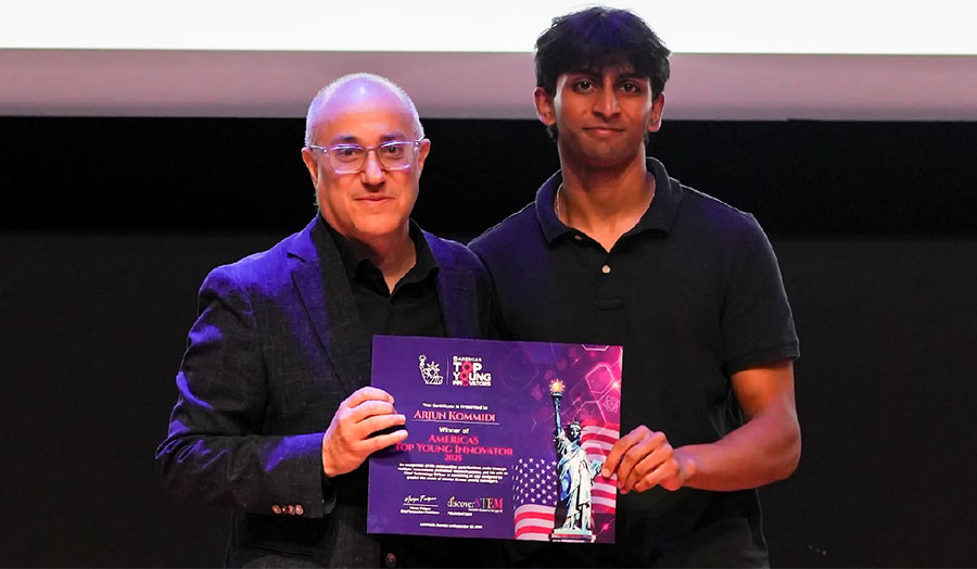 Arjun Kommidi (right) receives the America's Top Young Innovators 2025 award at the University of Texas at Dallas. Credit: DiscoverSTEM (sponsored)
